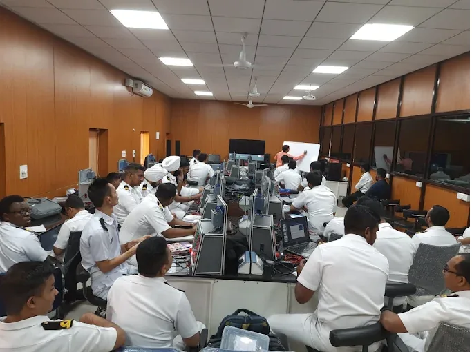 Participants attending a classroom training session at the Defence College