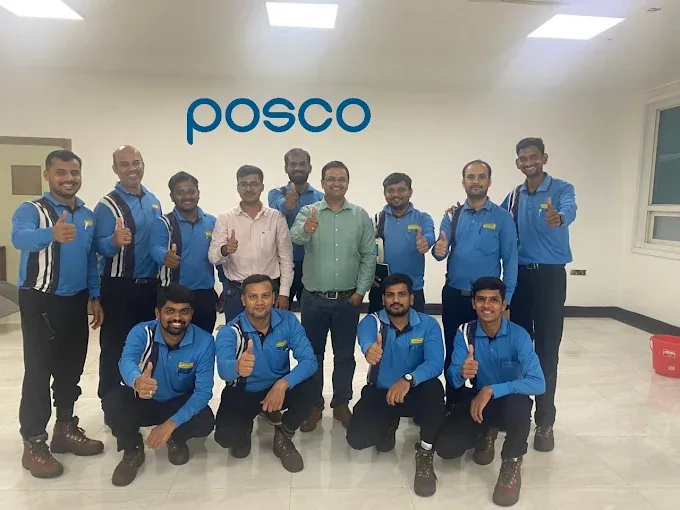 Training group photograph in front of the POSCO sign