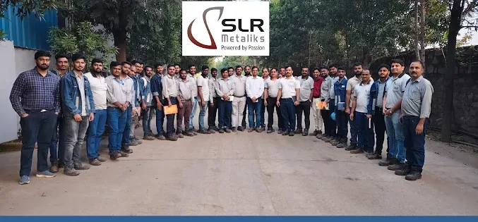 Training group photograph outside SLR Metaliks, Hospet